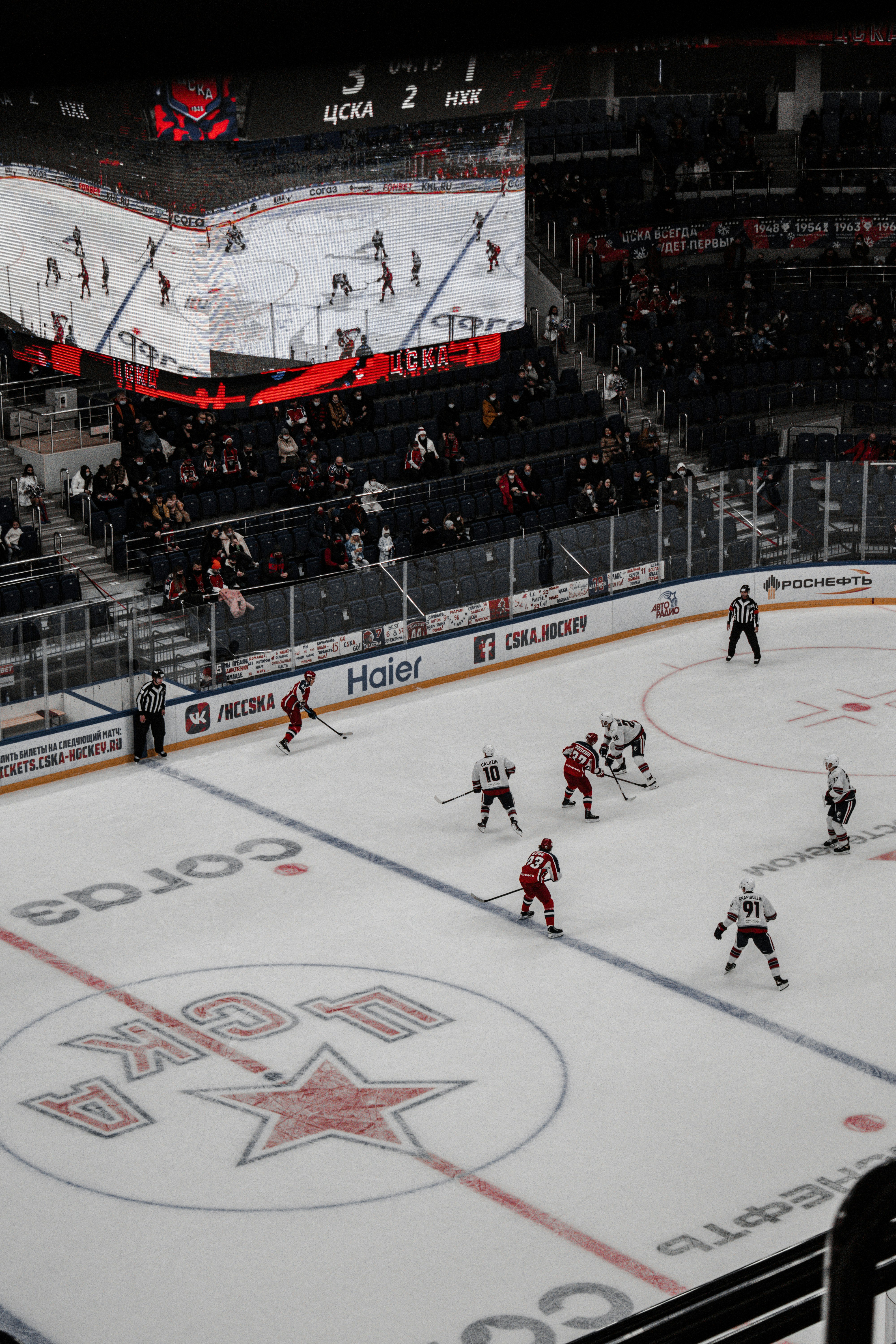 people playing ice hockey inside stadium